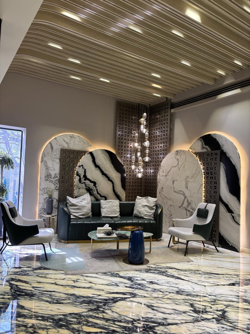 Waiting lounge with arched marble backdrops and crystal chandelier